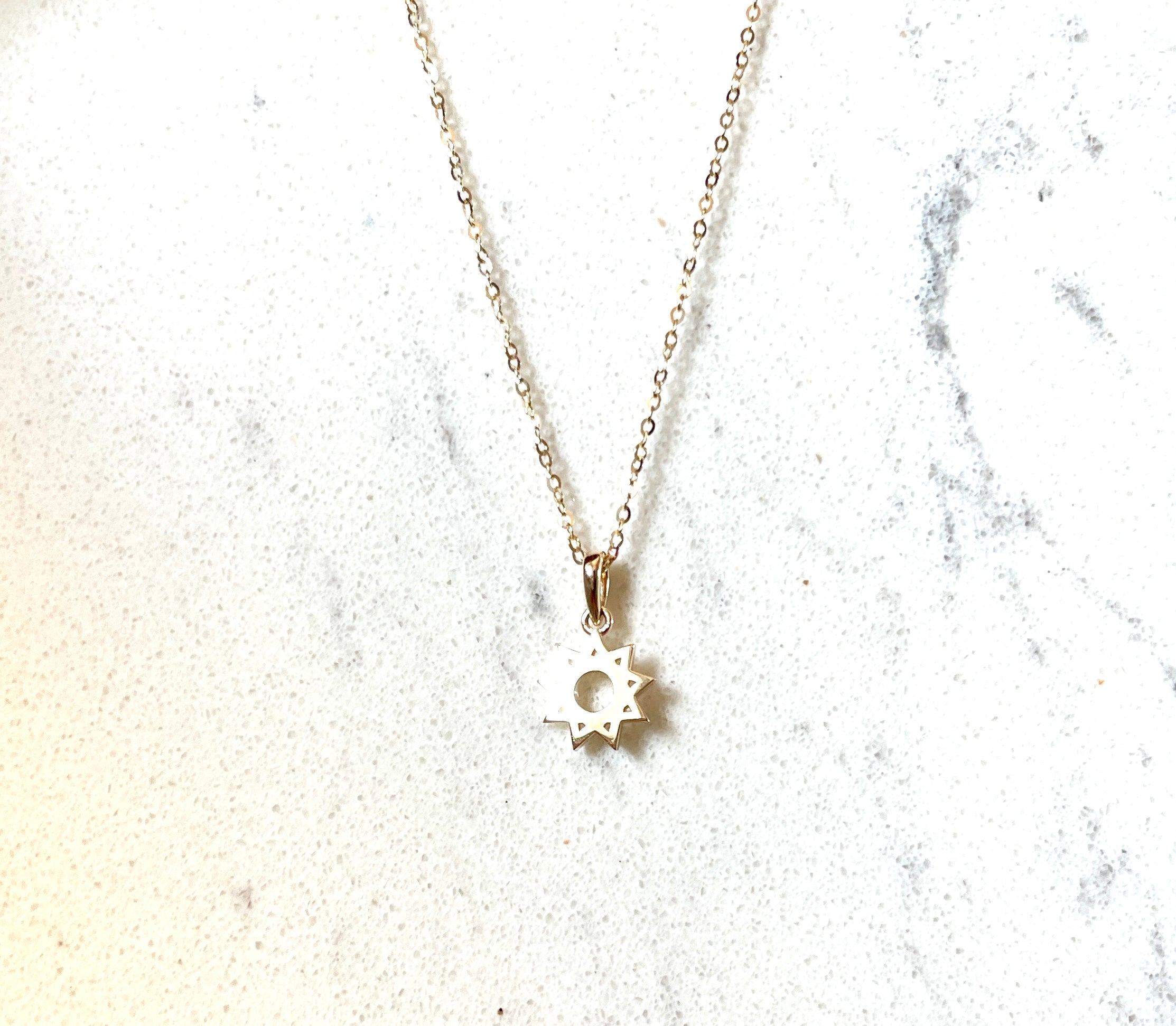simple nine pointed Bahai star pendant on 14k yellow gold necklace